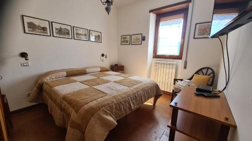 a bedroom with a bed and a desk with a lamp at Amazing Lake View in Castel di Tora