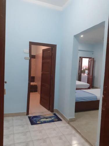 a room with a door and a bedroom with a bed at Nile Roof Hotel& Restaurant in Luxor