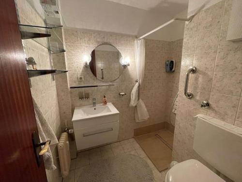 a bathroom with a sink and a toilet and a mirror at Relax Center Suite in Essen