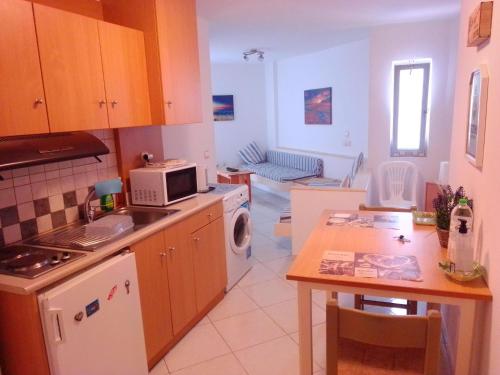 a kitchen with a table and a stove top oven at GT Apartment in Rhodes Town