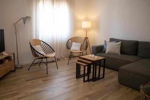 a living room with a couch and two chairs and a table at Casa Boa Onda in Sagres