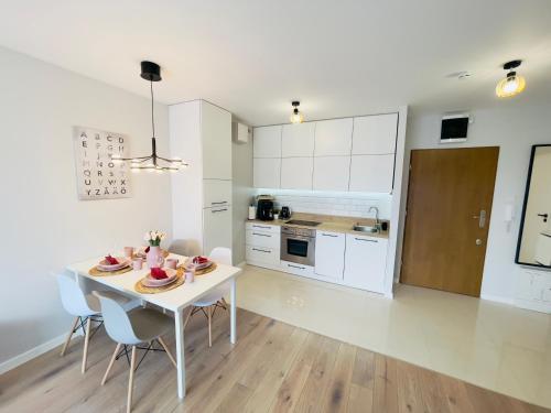 a kitchen and dining room with a table and chairs at Golden Tobaco in Łódź