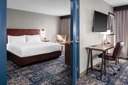 a hotel room with a bed and a desk at Four Points by Sheraton Memphis East in Memphis