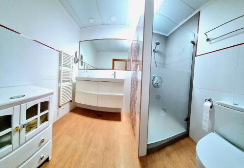 a bathroom with a sink and a shower and a mirror at Casa de la Luz in Carboneras