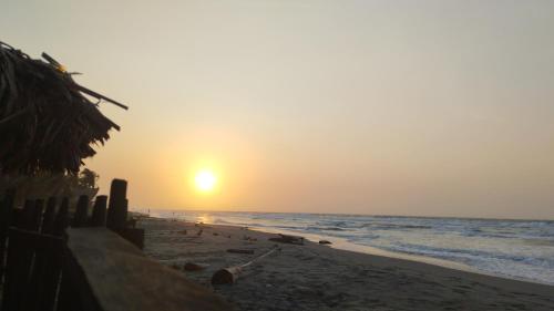 a sunset on a beach with the ocean at Antara del Mar in San Bernardo del Viento