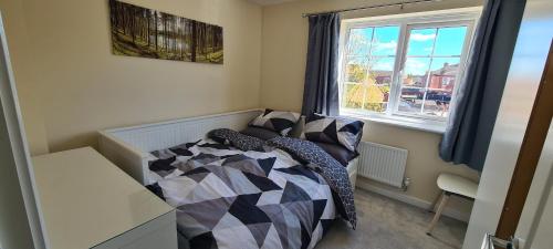 a small bedroom with a bed and a window at Wishart Drive 