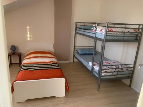 a bedroom with two bunk beds in a room at Appartement en zone pavillonnaire in Drancy