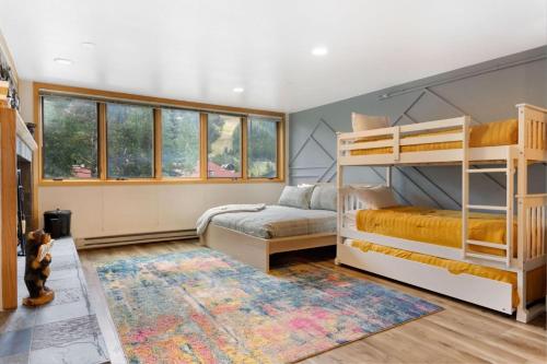 a bedroom with two bunk beds and a rug at Liftside 104 - Keystone in Keystone