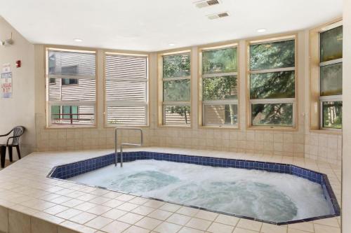 a jacuzzi tub in a room with windows at Liftside 104 - Keystone in Keystone