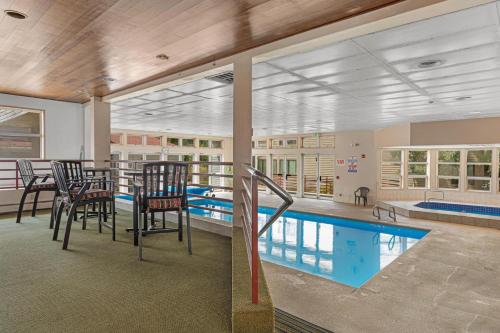 a pool room with chairs and a table and a swimming pool at Liftside 104 - Keystone in Keystone