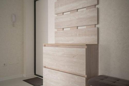 a wooden wall in a room with a bench at RentWill apartments Sixteen in Chişinău