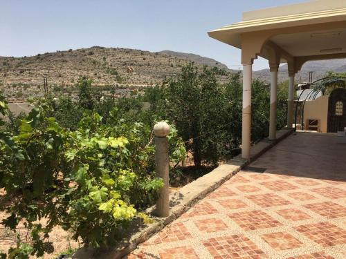 a porch of a house with a view of a mountain at الجبل الاخضر سيق ( بيت الصوير ) in Sayq