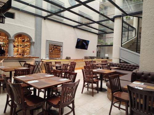 a dining room with wooden tables and chairs at Hotel Marques Del Valle in Oaxaca City