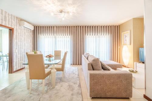 a living room with a couch and a table at Alohouse Nazaré in Nazaré