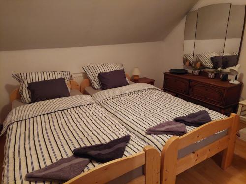 a bedroom with a large bed and a dresser at Patak Üdülőház (Ferienhaus) in Nagyvisnyó