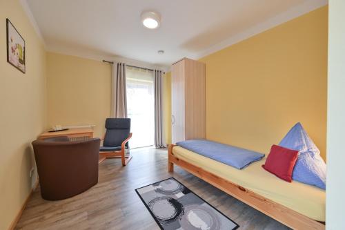 a room with a bed and a desk and a chair at Rote Villa Füssen in Füssen