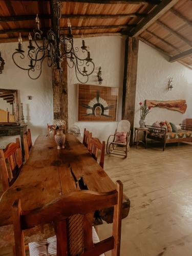 a large dining room with a wooden table and chairs at Casa Amada in Arraial d'Ajuda