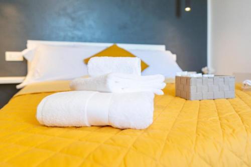 a pile of towels sitting on top of a bed at TibetiAmo in Castelsaraceno