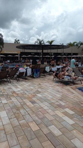 eine Gruppe von Menschen, die in Gartenstühlen in einem Resort faulenzen in der Unterkunft Solar das Águas Park Resort in Olímpia