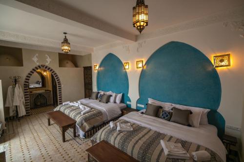 Кровать или кровати в номере Riad Jouba