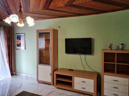 a living room with a flat screen tv on the wall at ND SMART RESIDENCE in Limbe