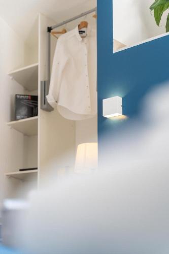 a white cabinet with a white shirt hanging on it at TibetiAmo in Castelsaraceno