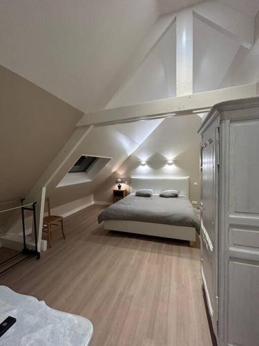 une chambre avec un lit dans un grenier dans l'établissement Maison familiale face à la mer, à Regnéville-sur-Mer