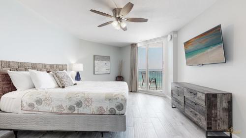 a bedroom with a bed and a ceiling fan at Beachfront - Renovated - Gulf view Bedroom - FLPCB5 in Panama City Beach