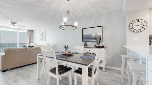 a dining room and living room with a table and chairs at Beachfront - Renovated - Gulf view Bedroom - FLPCB5 in Panama City Beach