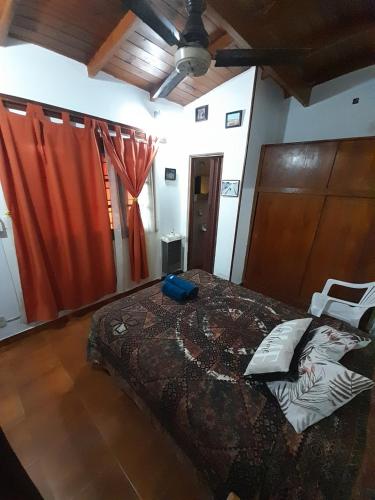 a bedroom with a large bed with red curtains at Mar del Plata in Mar del Plata