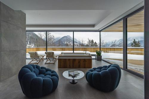 a living room with a view of the mountains at Chalet Sofija in Gozd Martuljek