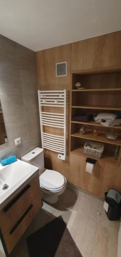 a bathroom with a white toilet and a sink at Le Phare in Cogolin