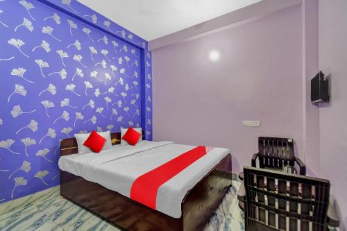 a bedroom with a bed with a blue and white wall at Flagship Heritage Inn in Cuttack