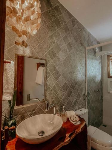 a bathroom with a sink and a mirror at Casa Amada in Arraial d'Ajuda