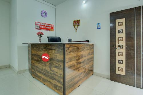 an office with a counter with a stop sign on it at Flagship Hotel Pragya 3 New in Raipur