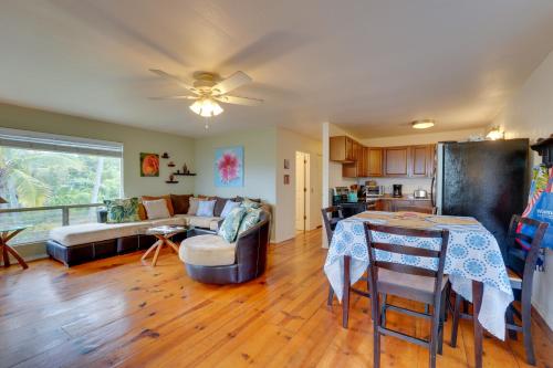 a living room with a couch and a table at Breezy Kailua-Kona Bungalow with Lanai and Ocean View! in Kailua-Kona