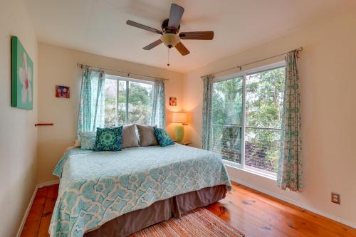 a bedroom with a bed and a ceiling fan at Breezy Kailua-Kona Bungalow with Lanai and Ocean View! in Kailua-Kona