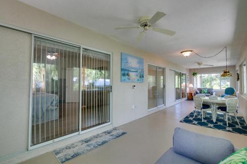 a living room with a ceiling fan and a table at Canal-Front Retreat in Crystal River! in Crystal River