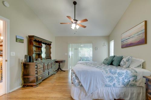 a bedroom with a bed and a ceiling fan at Crystal River Vacation Rental on Canal! in Crystal River