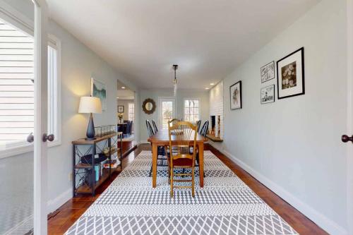 a dining room with a table and a white wall at White Oaks in Branford