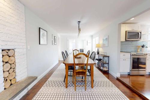 a dining room with a table and a fireplace at White Oaks in Branford