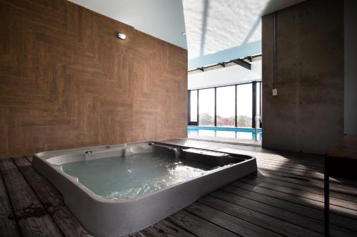 a large bath tub in a room with a wooden floor at 72 HUB Apartments - Great View - Gym - Rooftop in Bogotá