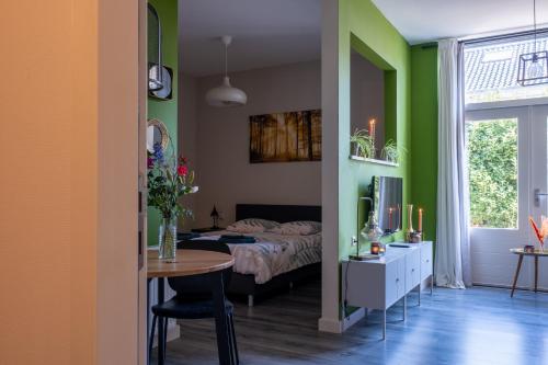 a bedroom with a bed and a table in a room at @ geulle in Guelle