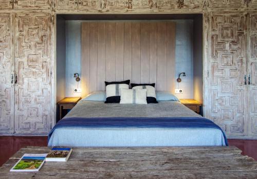 a bedroom with a large bed with two pillows at Finca Bell-Lloc in Palamós