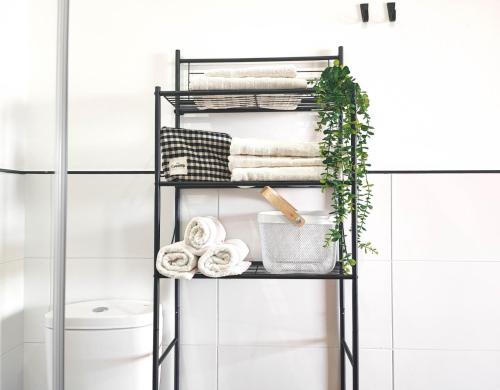 a black towel rack in a bathroom with towels at Mirador do Mar, encima de la playa in Moaña