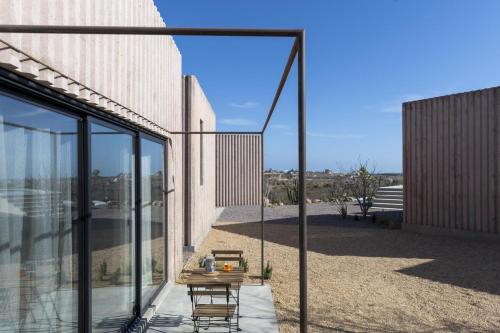 a balcony with a table and chairs on a building at Casa Santos in Todos Santos