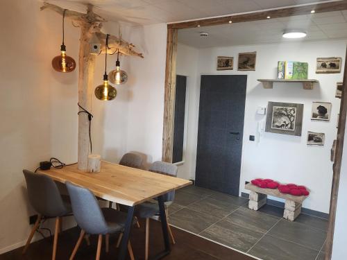 a dining room with a wooden table and chairs at Apartment Fabelwald Black Forest in Schonach