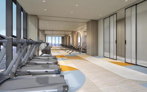 a gym with treadmills and elliptical machines at Crowne Plaza Hangzhou Riverside by IHG in Hangzhou