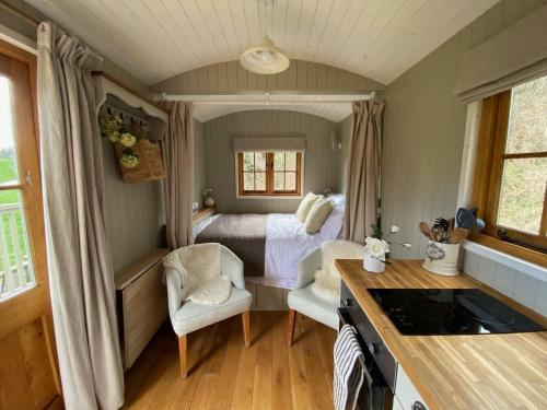 a small room with a bed and a bedroom at Kingfisher in Chirk