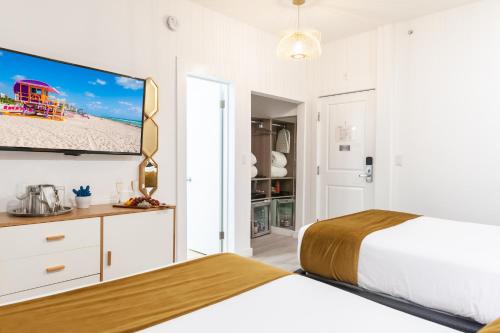 a bedroom with a bed and a flat screen tv at Catalina Hotel & Beach Club in Miami Beach